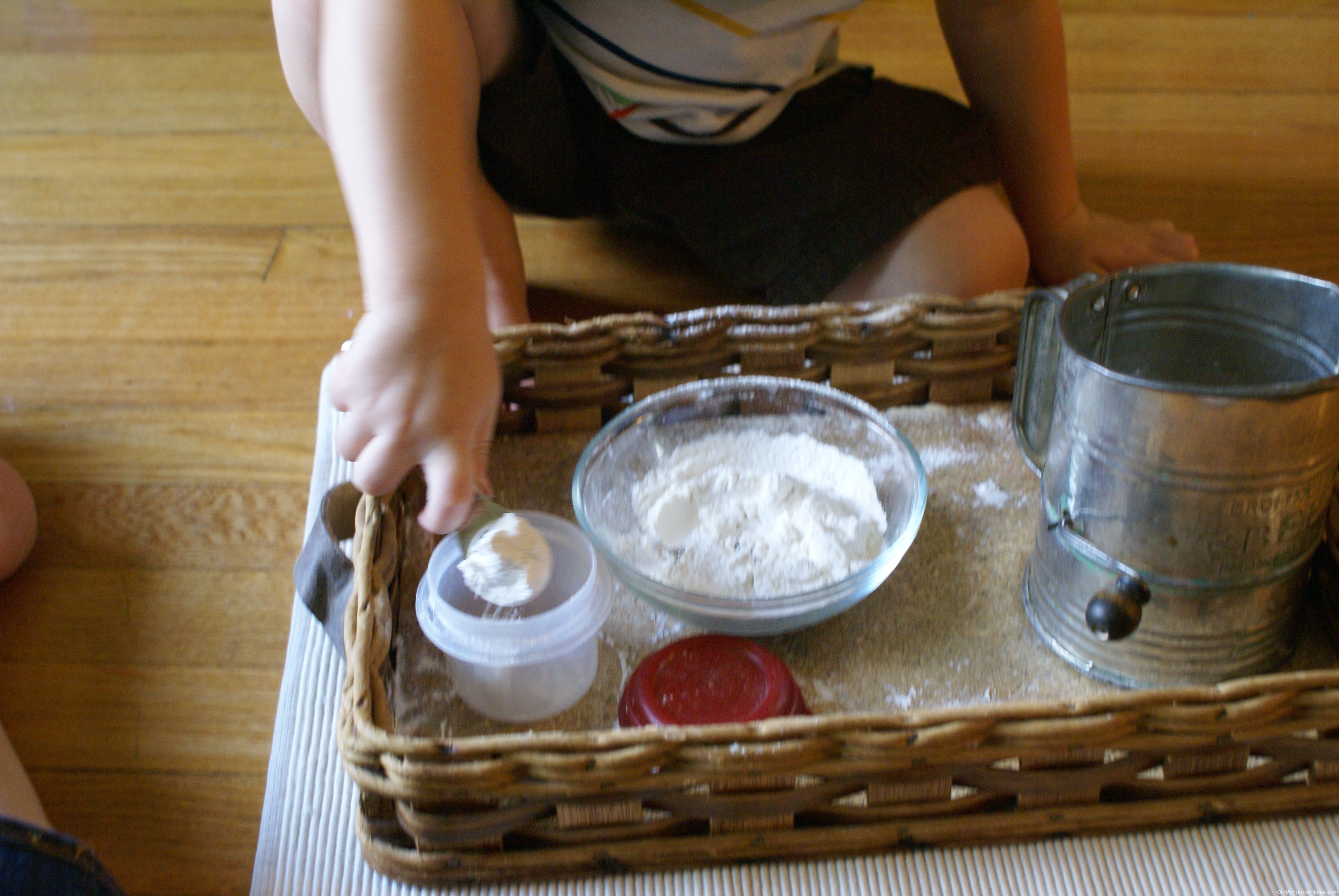 http://www.ourmontessorihome.com/wp-content/uploads/2011/07/spooning-flour-back-into-bowl.jpg